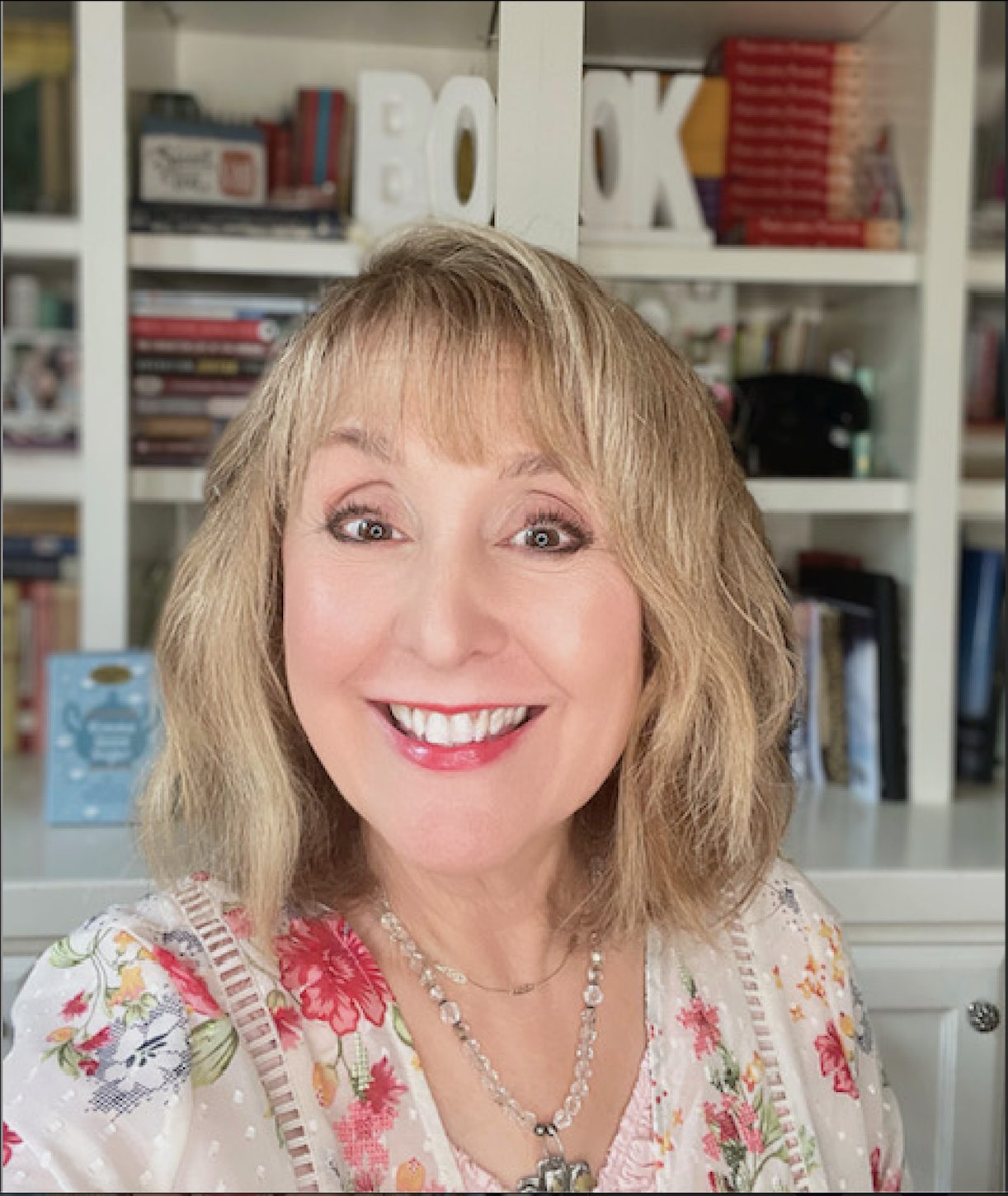 Linda Kozar Headshot Image of Linda Kozar with a book shelf in background
